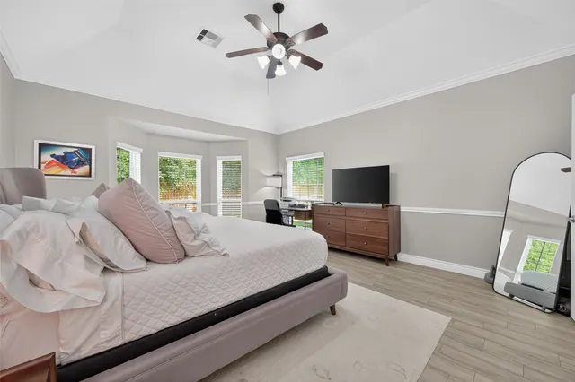 a bedroom with a bed a couch and a window