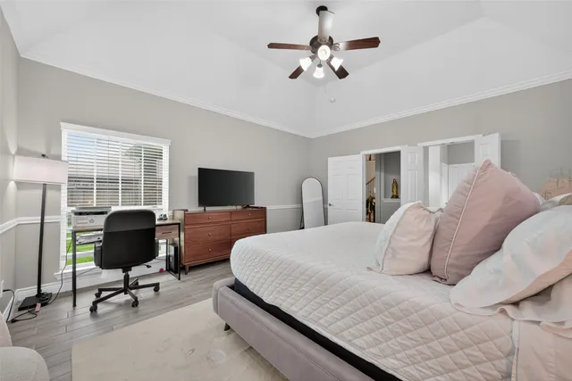 a bedroom with a bed a chair and a chandelier