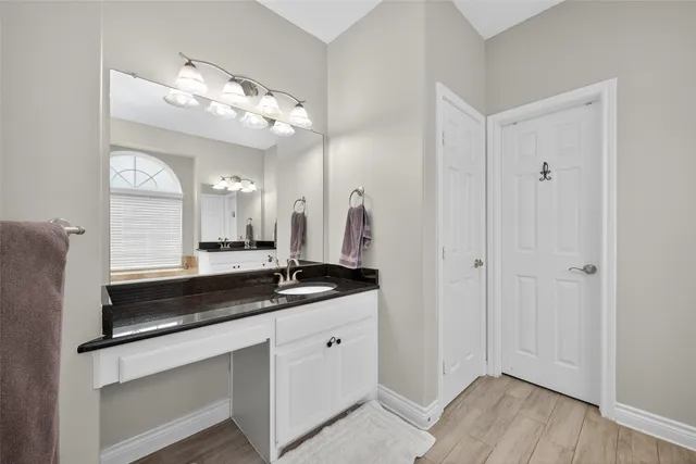 a bathroom with a sink vanity and mirror
