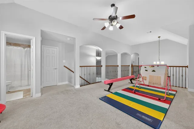 a room with pool table and windows