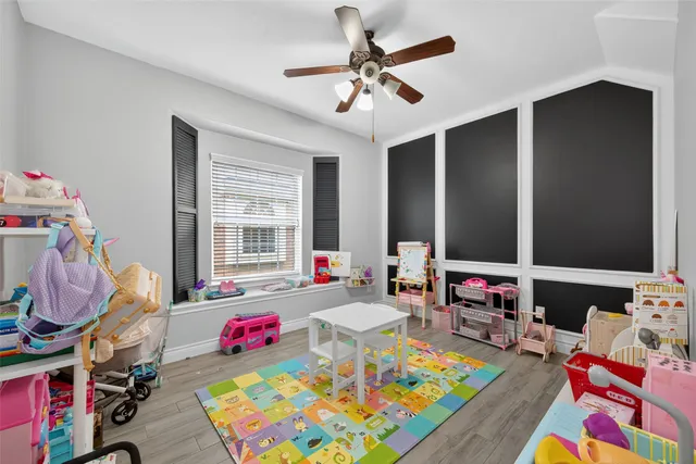 a play room with furniture and a flat screen tv