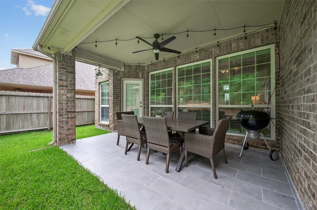 a view of a house with backyard and porch