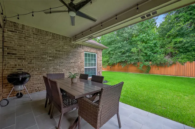 a backyard of a house with table and chairs