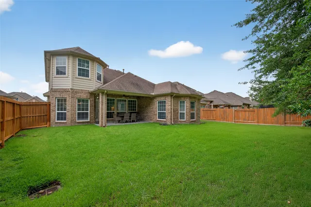 a view of a house with a yard and a garden