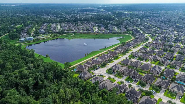 an aerial view of a houses with a yard