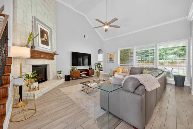 a living room with furniture a fireplace and a flat screen tv