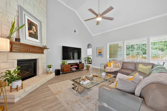 a living room with furniture a fireplace and a flat screen tv