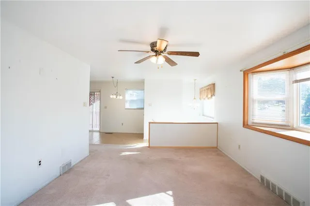a view of a livingroom with a ceiling fan and window