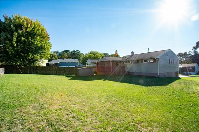 a view of a house with a yard and a small yard