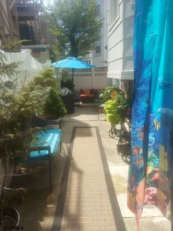 a view of a chairs and table in a balcony