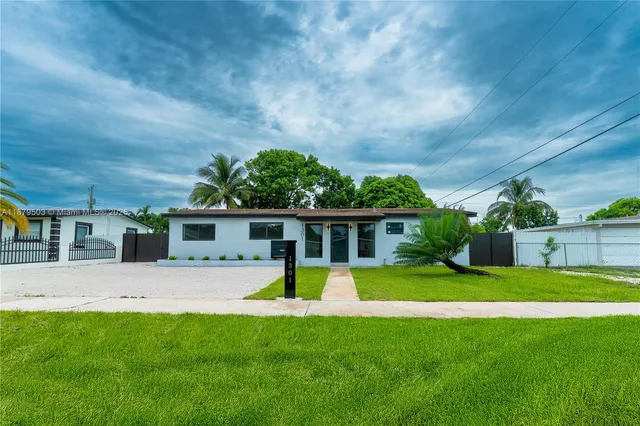 a view of a house with a yard and plants
