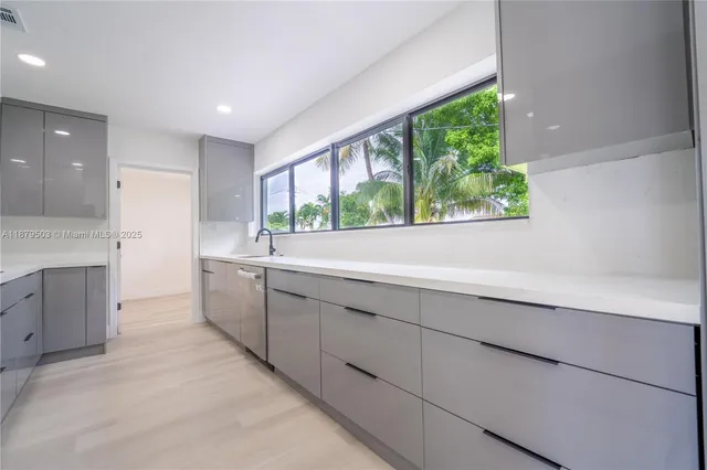 a view of a kitchen with a sink and window