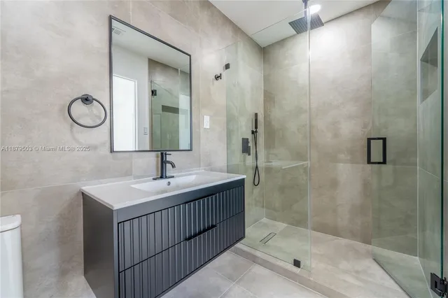 a bathroom with a sink a shower and a mirror