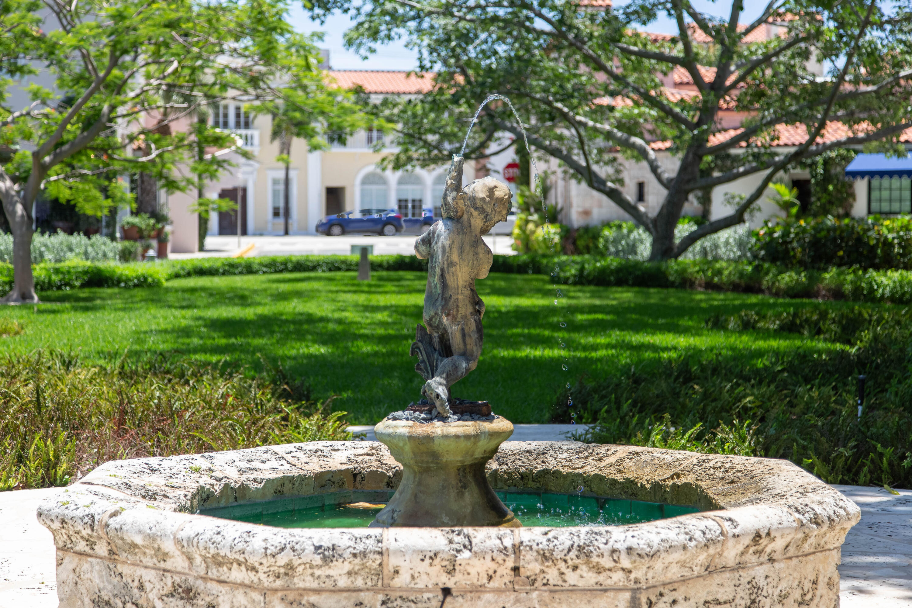 236 Phipps Plaza, Unit D Palm Beach, FL 33480 - Photo 45 of 55 a view of a fountain in a yard with palm trees