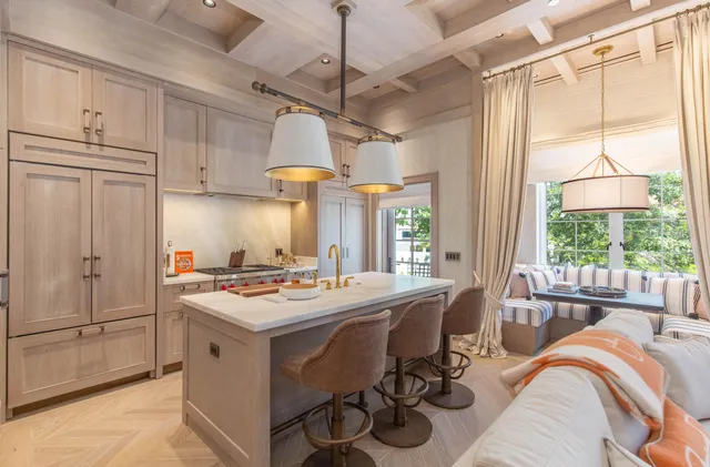 a kitchen with a stove a refrigerator and a dining table with painted walls