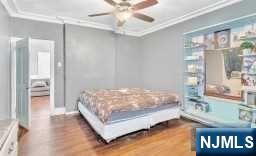 452 Minton Place Orange, NJ 07050 - Photo 14 of 14 a bed sitting in a room next to a window