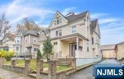 452 Minton Place Orange, NJ 07050 - Photo 3 of 14 a view of a white building with a large windows