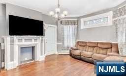 452 Minton Place Orange, NJ 07050 - Photo 4 of 14 a living room with furniture a flat screen tv and a fireplace