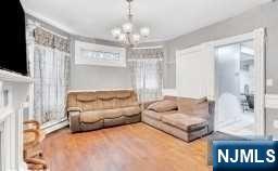 452 Minton Place Orange, NJ 07050 - Photo 5 of 14 a living room with furniture and a chandelier