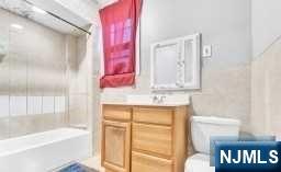 452 Minton Place Orange, NJ 07050 - Photo 7 of 14 a bathroom with a bathtub and a shower