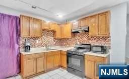 452 Minton Place Orange, NJ 07050 - Photo 9 of 14 a kitchen with stainless steel appliances granite countertop a stove a sink and a microwave