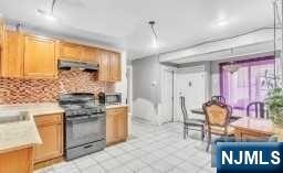 452 Minton Place Orange, NJ 07050 - Photo 10 of 14 a kitchen with stainless steel appliances granite countertop a stove and a refrigerator