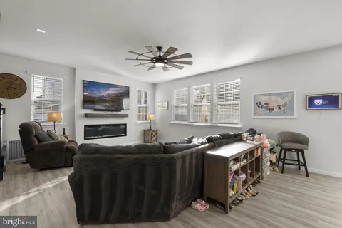 a large dining hall with stainless steel appliances granite countertop a stove and a living room view