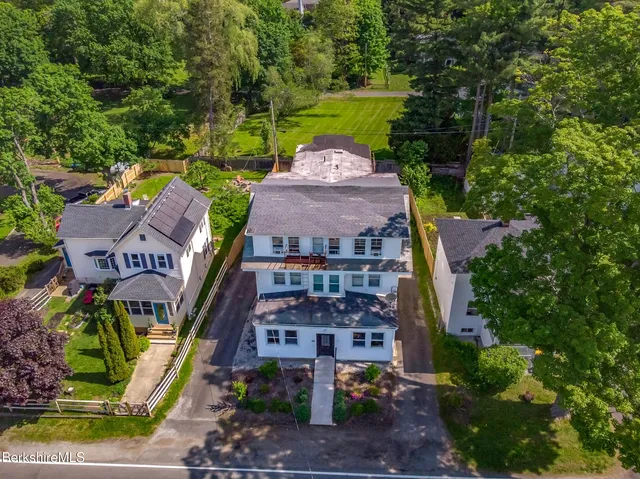 an aerial view of a house with garden space and street view