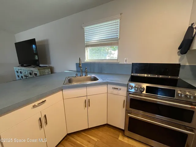 a kitchen with microwave a stove and a sink