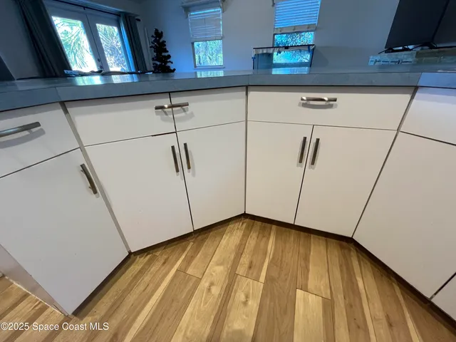 a view of a room with wooden floor and cabinet