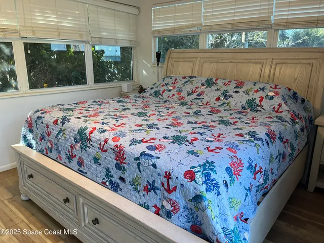 a bed sitting in a bedroom next to a window