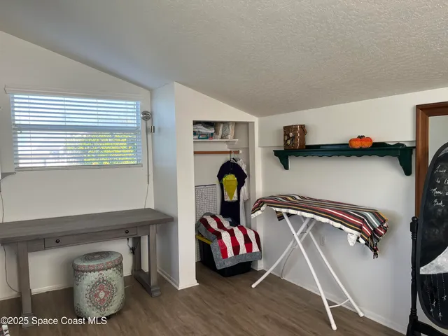 a view of balcony with wooden floor and fence