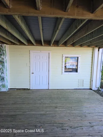 a balcony with furniture and a potted plant