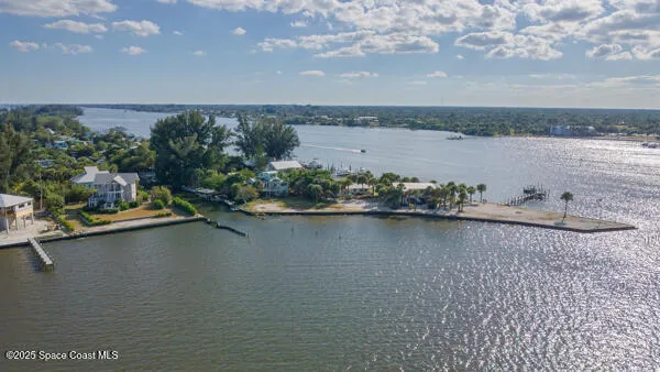 an aerial view of a house with a lake view