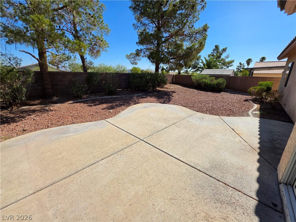 1154 Point Success Avenue Henderson, NV 89014 - Photo 24 of 26 A low-maintenance yard offers both paved patio space and rock landscaping, ideal for outdoor leisure.