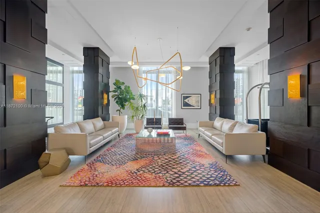a living room with furniture rug and a large window