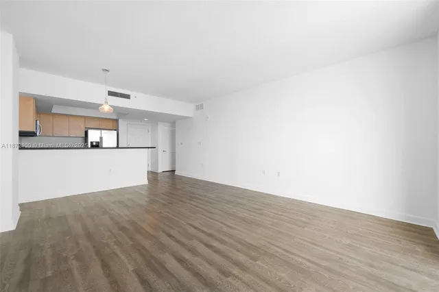 a view of a kitchen with wooden floor and a sink