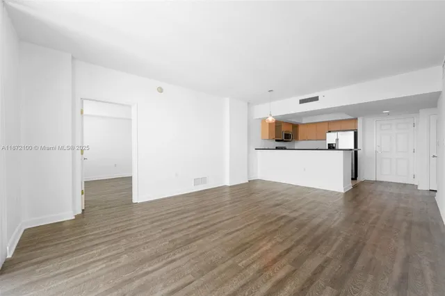 a view of a kitchen with a sink and a microwave