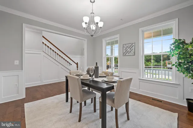 a view of a dining room with furniture and window