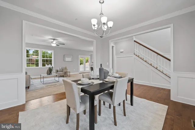 a view of a dining room with furniture and a chandelier