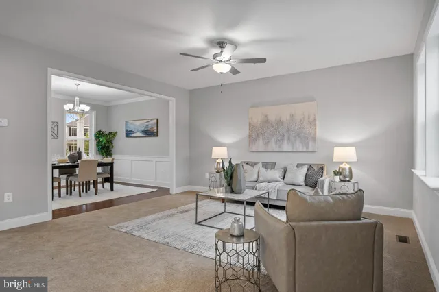 a living room with furniture and a chandelier