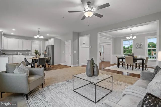 a living room with furniture and kitchen view
