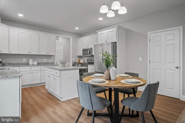 a kitchen with a table and chairs in it