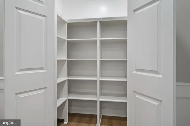 a view of walk in closet with empty racks