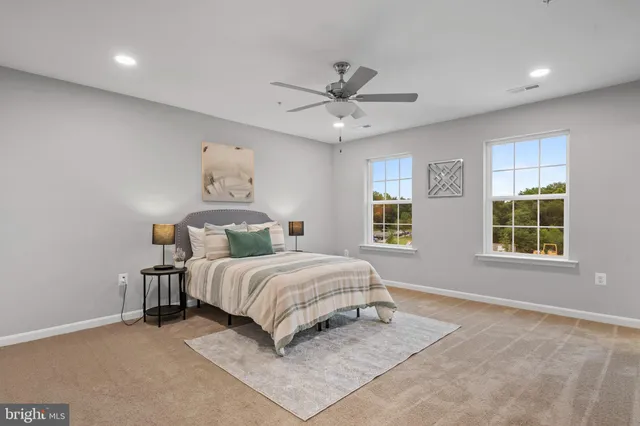 a spacious bedroom with a bed and a window