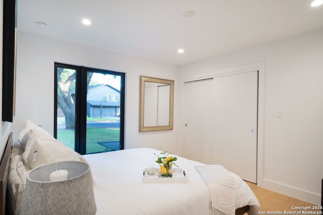 8900 Point W Drive Austin, TX 78759 - Photo 15 of 29 a bed sitting in a bedroom next to a window