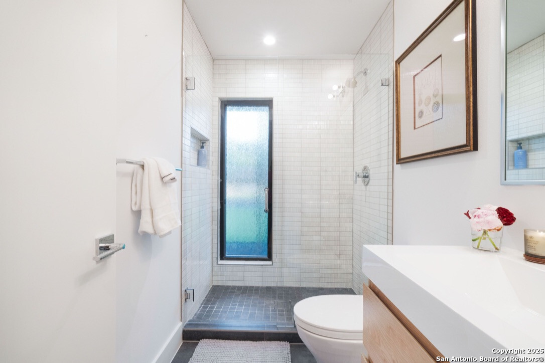 8900 Point W Drive Austin, TX 78759 - Photo 16 of 29 a bathroom with a sink a toilet and shower