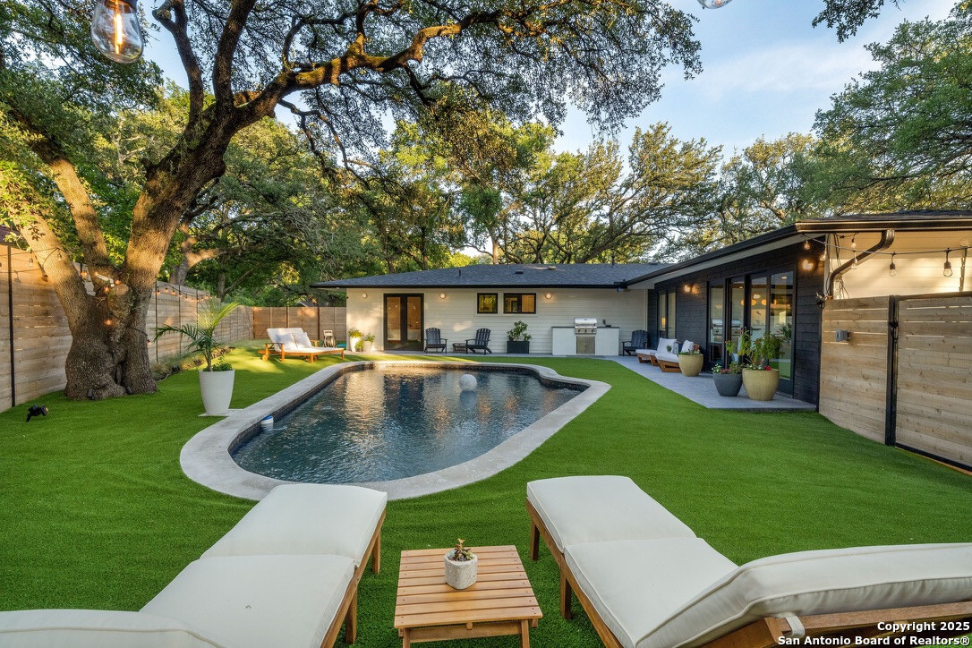 8900 Point W Drive Austin, TX 78759 - Photo 24 of 29 a view of a patio with table and chairs and a barbeque with wooden fence