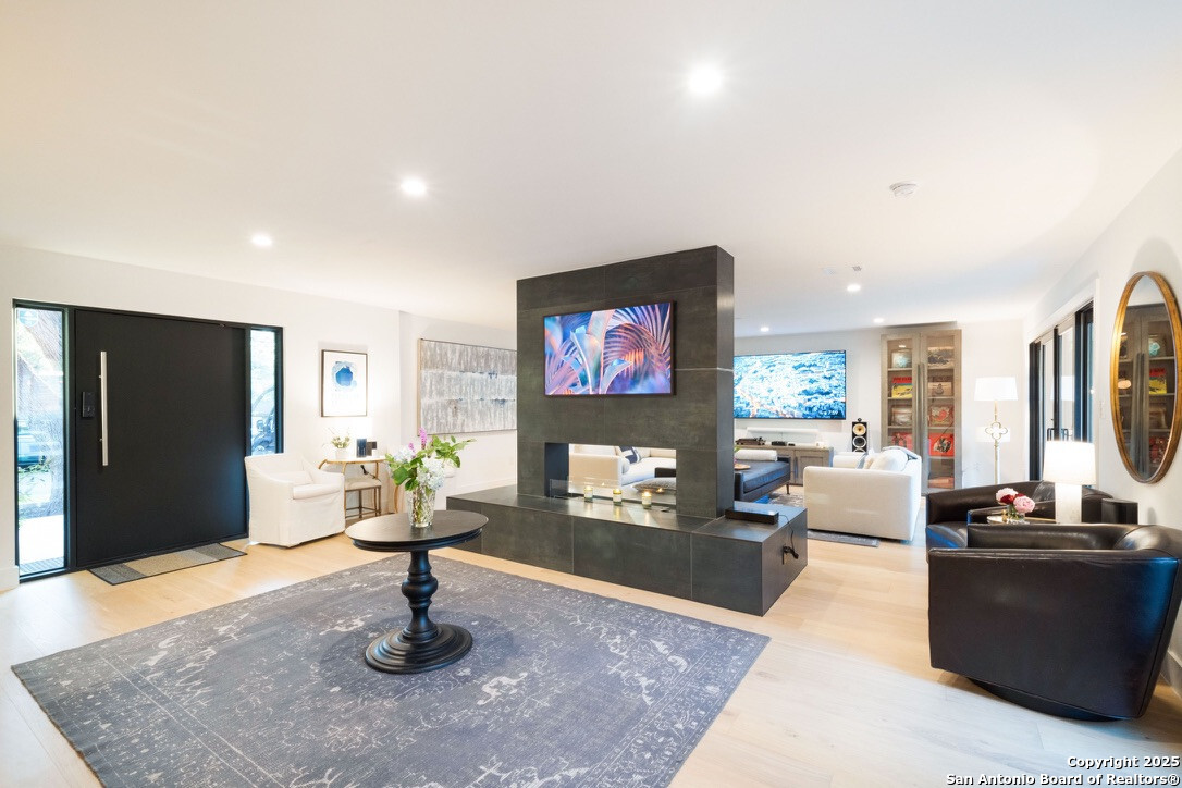 8900 Point W Drive Austin, TX 78759 - Photo 3 of 29 a living room with fireplace furniture and a flat screen tv