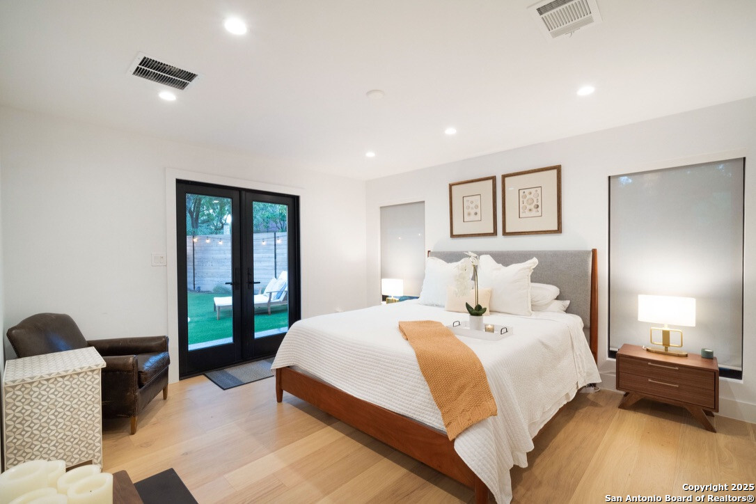 8900 Point W Drive Austin, TX 78759 - Photo 9 of 29 a spacious bedroom with a bed and a large window